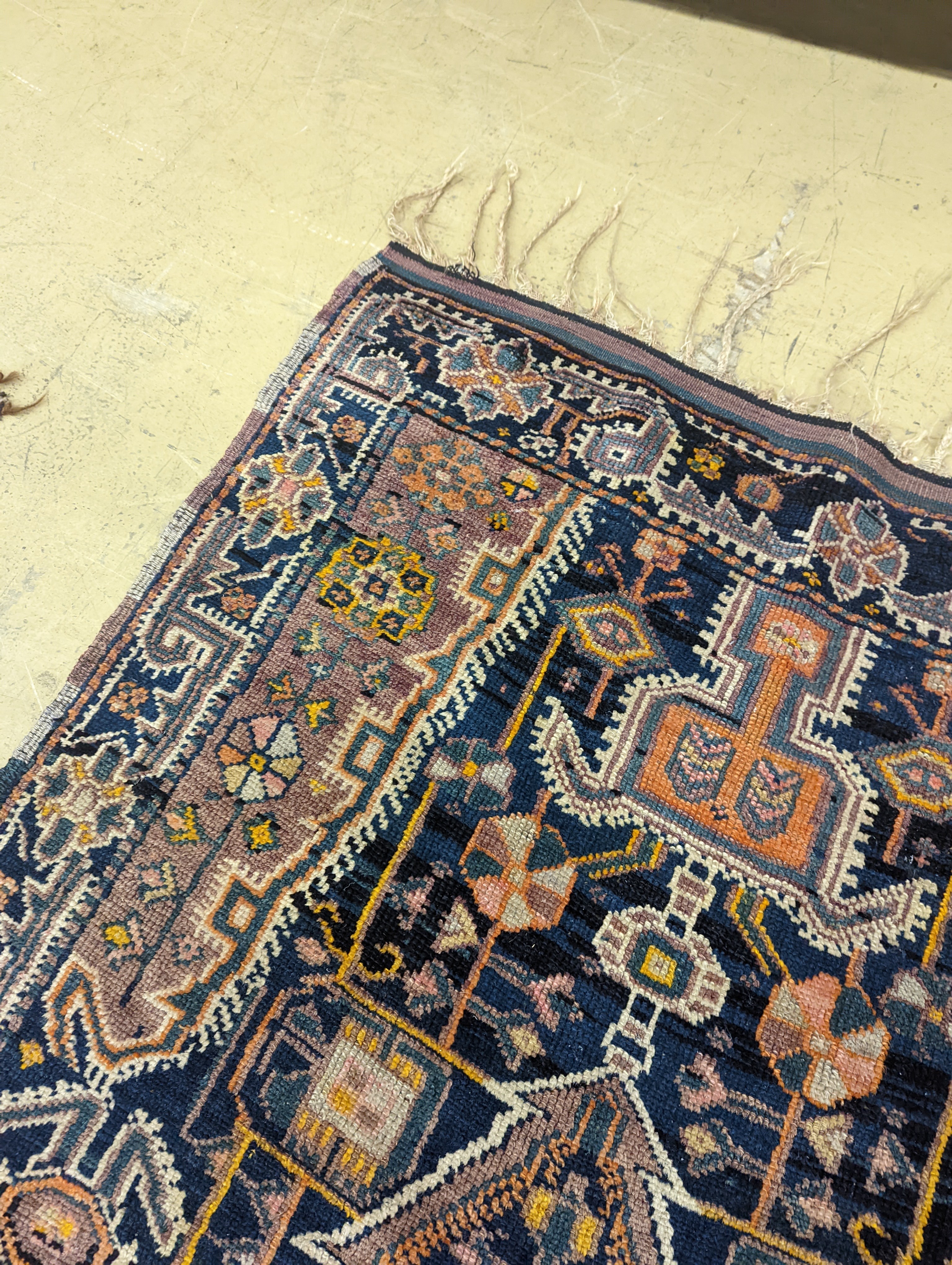 A Caucasian design blue ground rug, 224 x 111cm